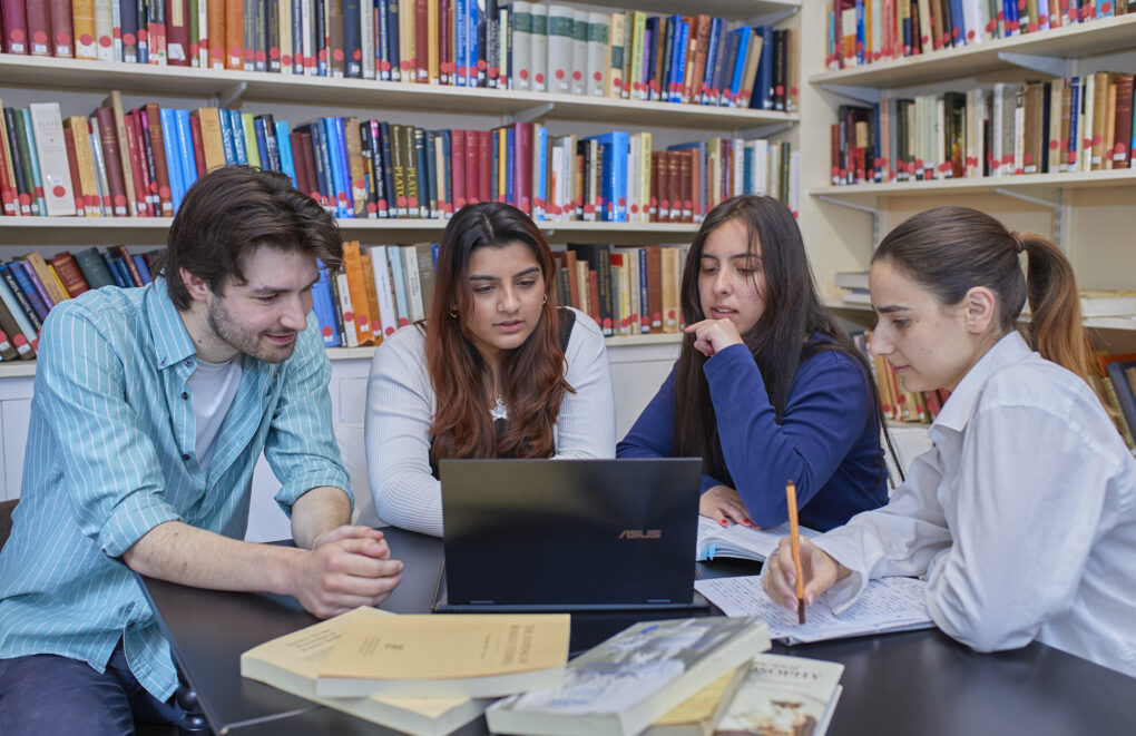 A group of classics students working at a table